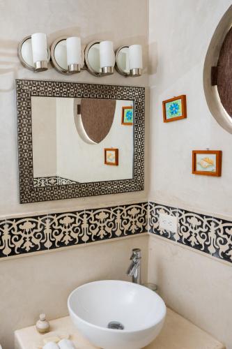 a bathroom with a sink and a mirror at Boutique by The Museo in Mérida