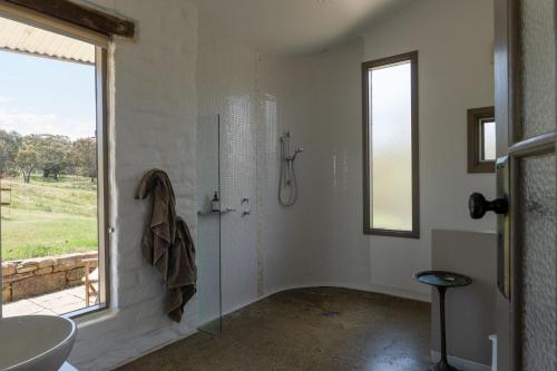a bathroom with a shower and a sink and a window at Lithia Guest House - Daylesford Region in Hepburn Springs