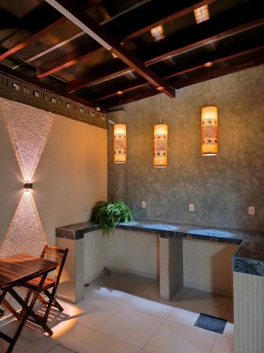 a bar in a room with a table and chairs at Hotel Pousada Velas ao Mar in Maceió