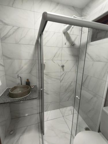 a bathroom with a shower with a toilet and a sink at Hotel Pousada Velas ao Mar in Maceió