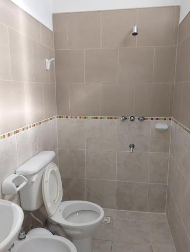 a bathroom with a white toilet and a sink at Las Dos Tinajas in La Punta