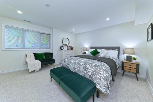 a bedroom with a large bed and a chair at SPACIOUS FULLY PRIVATE 2BR UNIT ON GROUND Private 2BR LEVEL in Burlington