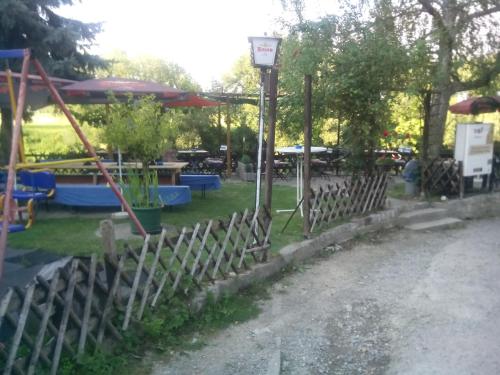 a fence with a street light next to a park at Pension Gasthaus zum Pegel in Naumburg