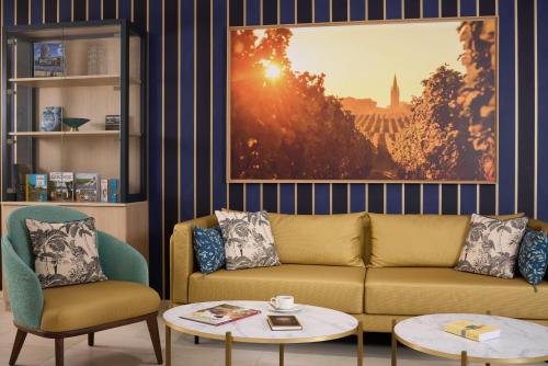 a living room with a couch and two chairs at Zenitude Hôtel-Résidences Bordeaux Saint-Jean in Bordeaux