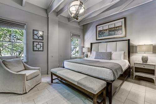a bedroom with a large bed and a chair at Parker's Collection Unit 5 in Savannah