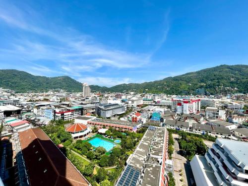 an aerial view of a city with mountains in the background at Patong Tower Holiday Rentals in Patong Beach
