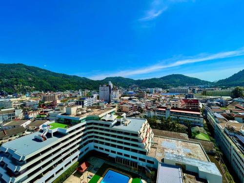 a view of a city with mountains in the background at Patong Tower Holiday Rentals in Patong Beach