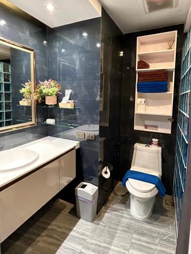 a bathroom with a toilet and a sink at Patong Tower Holiday Rentals in Patong Beach