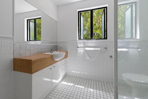 a white bathroom with a sink and a shower at 3 Hilltop Villas White Water Views from the Heart of Sunshine in Sunshine Beach