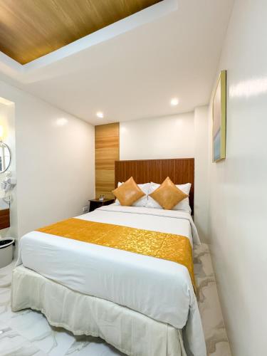 a bedroom with a large bed in a room at Hotel Adelina Balanga City Bataan in Balanga