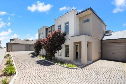 a large white house with a parking lot at Aldinga Horizon in Aldinga Beach