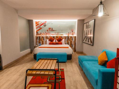 a hotel room with a bed and a couch at Meotel Purwokerto in Purwokerto