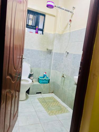 a bathroom with a shower and a toilet at Stylish 1 Bedroom Apartment in Kitengela 