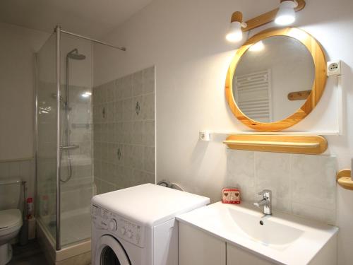 a bathroom with a sink and a washing machine at Appartement T2 Centre-Ville, 6 Couchages - FR-1-415-189 in Le Mont-Dore