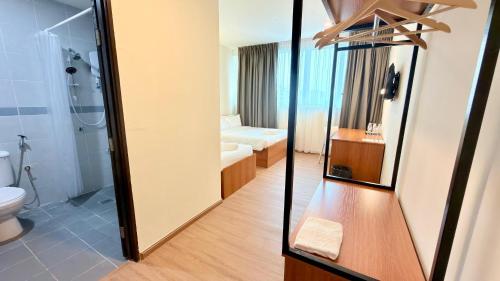 a bathroom with a shower and a toilet at DB Stay in Kuching