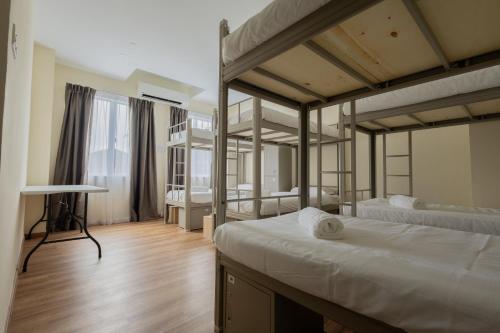 a bedroom with two bunk beds and a desk at DB Stay in Kuching