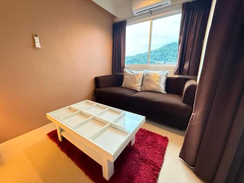 a living room with a couch and a coffee table at Aonang Mountain View A5 in Ao Nang Beach