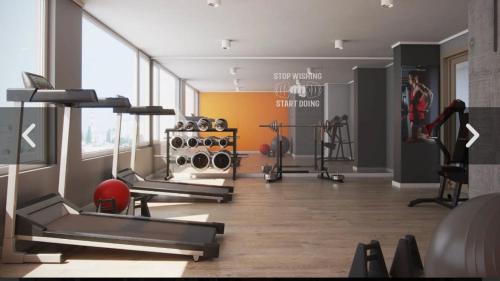 a gym with several treadmills and weights in a room at Central space in Concepción