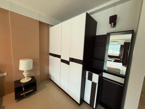 a room with a mirror and a bed and a lamp at Aonang Mountain View A5 in Ao Nang Beach