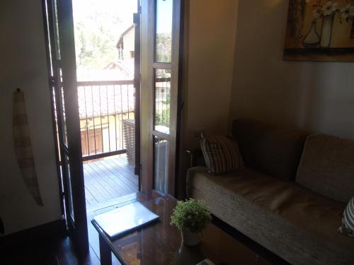 a living room with a couch and a sliding glass door at Enipnion Apartments in Kakopetria