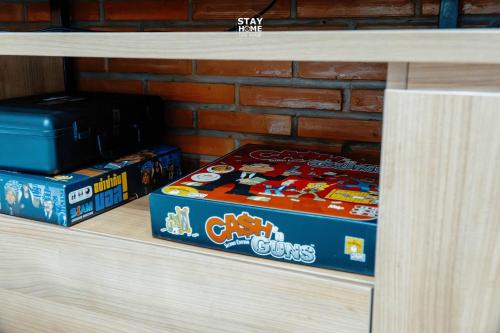 two boxes of candy on a wooden shelf at Loft Hatyai l ลอฟท์หาดใหญ่ in Hat Yai