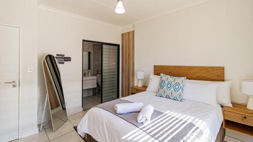 una camera da letto con un letto con asciugamani sopra di The Blyde @ 485 a Pretoria