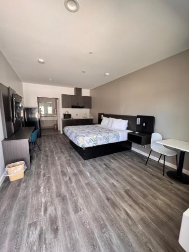 a bedroom with a bed and a desk and a table at Studio 6 Humble, TX in Humble