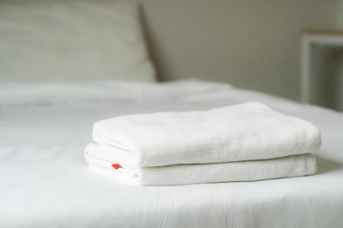 Giường trong phòng chung tại NP Place สันติธรรม - Mueang Chiang 2