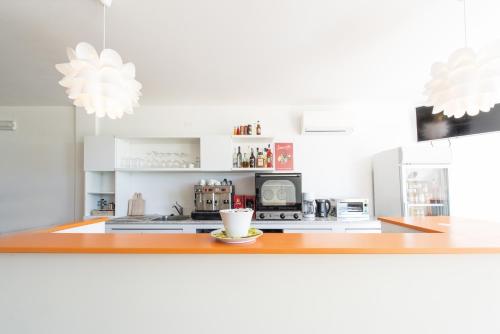 a kitchen with a counter with a cup of coffee at La Chioma di Berenice Garda Residence in Toscolano Maderno