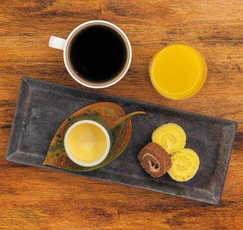 a plate with two cups of coffee and some donuts at Royal Park Hotel Takamatsu in Takamatsu