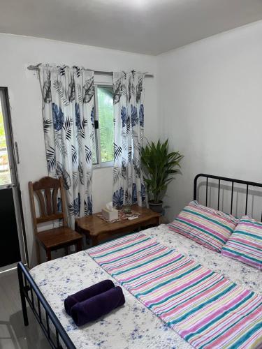 Ένα ή περισσότερα κρεβάτια σε δωμάτιο στο Paulines & Malinao Homestay