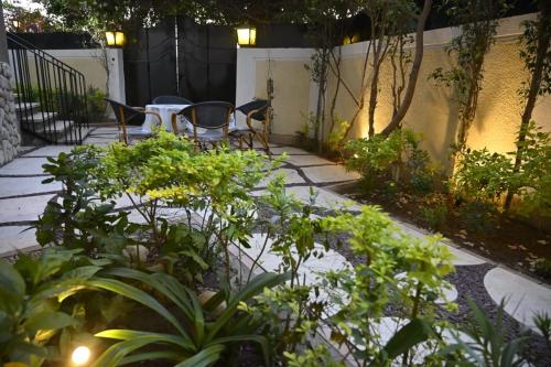un jardin avec une table, des chaises et des plantes dans l'établissement Villa Sela Gem, au Caire