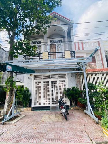 a motorcycle parked in front of a house at Aurora Homestay - Healing Phan Thiết in Phan Thiet
