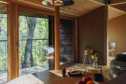 a living room with a large window in a house at SANU 2nd Home 北軽井沢 2nd in Kita-karuizawa
