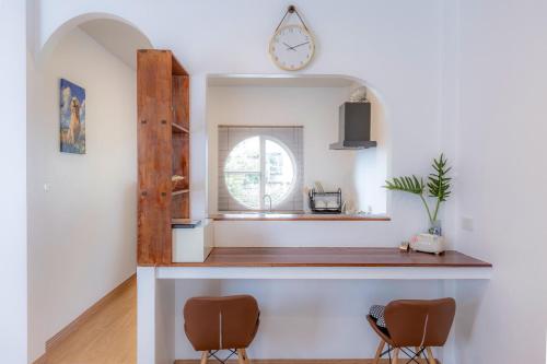 a room with two chairs and a clock on the wall at Sunrise Serenity Phuket Resort in Karon Beach