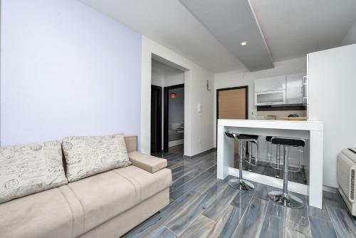 a living room with a couch and a kitchen at Boutique Apartments Blitz in Bibinje