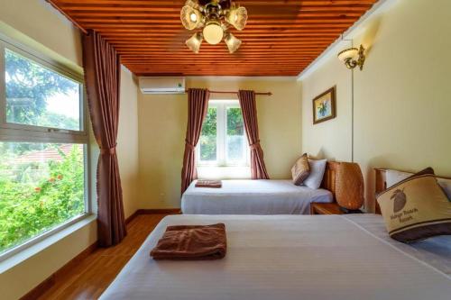 Postel nebo postele na pokoji v ubytování Mango Beach Resort