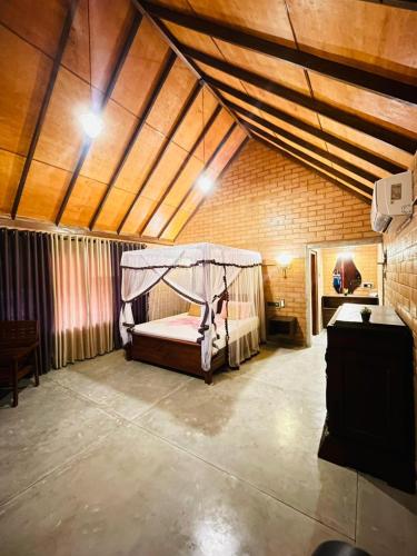 a bedroom with a bed in a large room at Ima Villa Sigiriya in Sigiriya