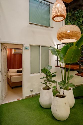 a room with two potted plants and a bedroom at Casa Amanzi Cartagena by Bernalo Hotels in Cartagena de Indias