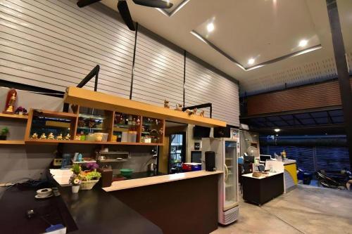 a kitchen with a counter and a refrigerator in a room at The Breeze Lipe Resort in Ko Lipe