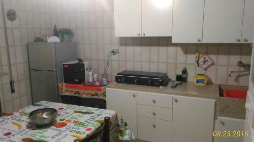a small kitchen with a table and a refrigerator at La Casa Di Azzurra in Parrinello 