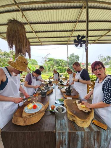 a group of people standing around a table preparing food at Phuket Nonnita Boutique Resort in Phuket