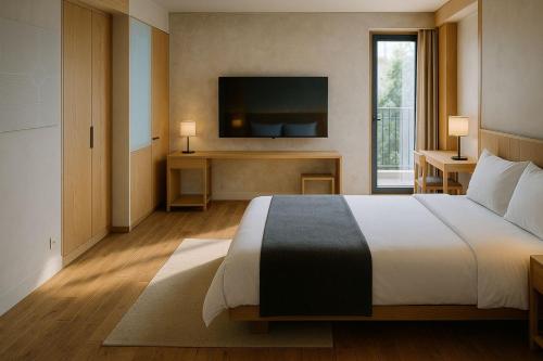 a bedroom with a large bed and a television at Wenjin Culu in Elbasan