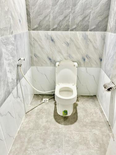 a bathroom with a white toilet in a room at Koh Rong Lagoon in Koh Rong Island