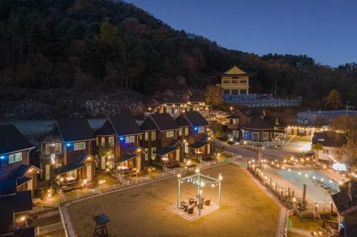 an aerial view of a resort with a pool at night at Gapyeong Haru Dog Pension in Oebang-ni