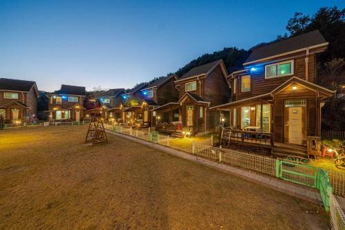 a group of houses in a yard at night at Gapyeong Haru Dog Pension in Oebang-ni