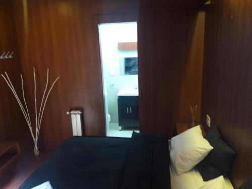 a bedroom with a bed and a window and a door at Onkel Inn Wagon Sleepbox Uyuni in Uyuni