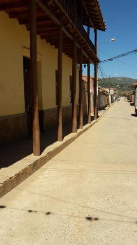 an empty street with a row of pillars on a building at Posada Guasu in Samaipata