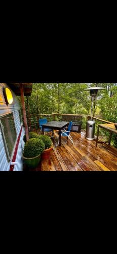 a deck with a table and chairs and a picnic table at Rancho Relaxo in Blackwood