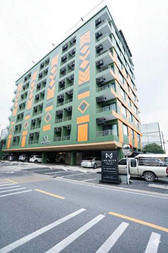 a large building with an advertisement on the side of it at Infinite Hotel-Ratchada in Bangkok